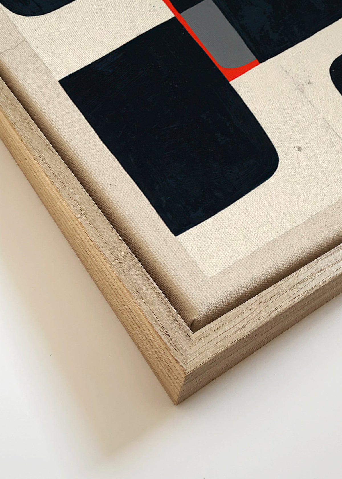 Cuadro geométrico con bloques negros y detalle rojo – Canvas detail